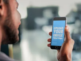 Stock Photo of a Young Man Using a Black iPhone 6 Smart Phone